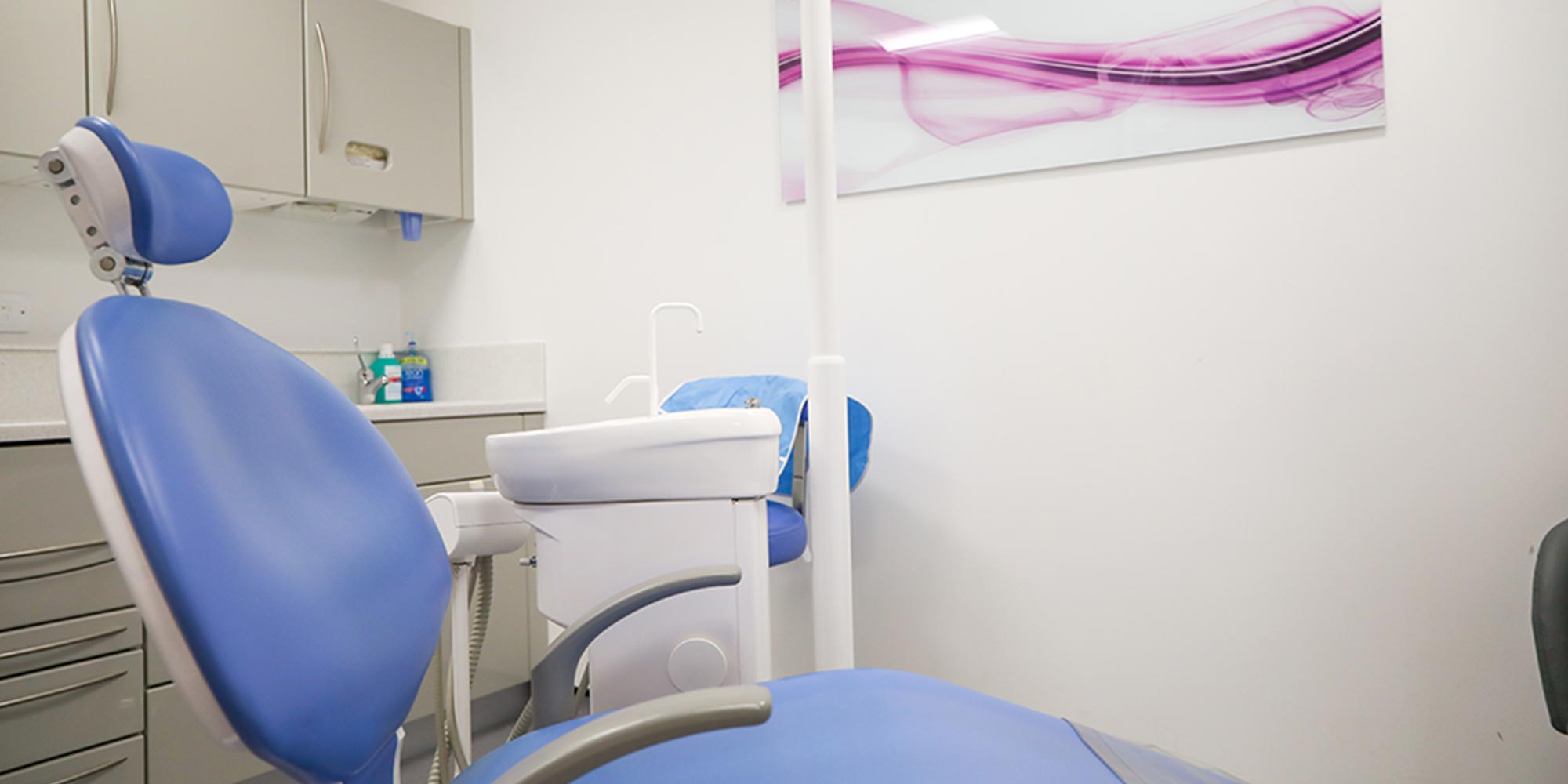 blue dental chair in treatment room